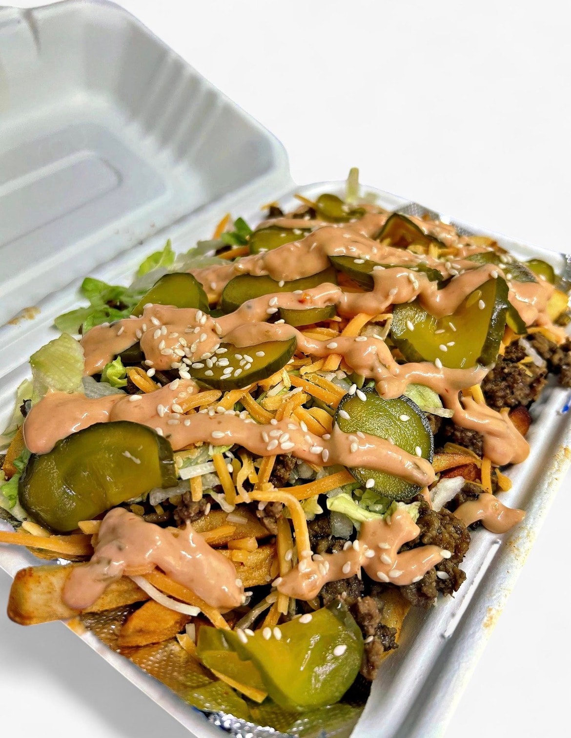 Loaded fries with pickles, cheese and sauce